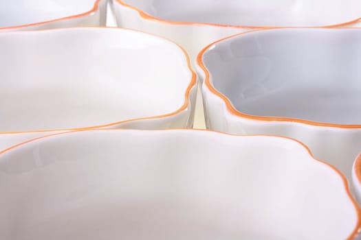 Empty pure cups of white colour with an orange border at restaurant.