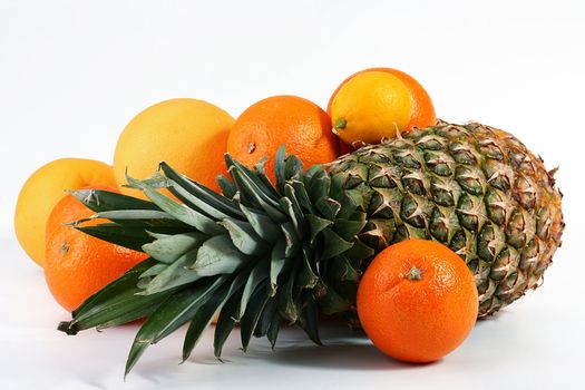 Pineapple with a lemon, oranges and grapefruits.