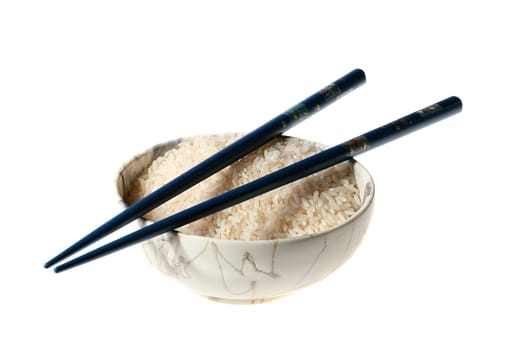 Soup plate with rice and two chopsticks.