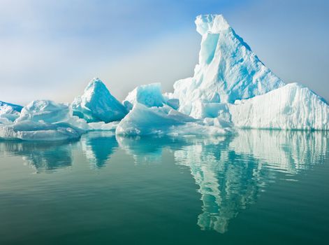 Icebergs floating in calm water.  Horizontally framed shot.