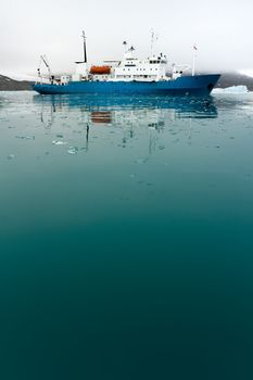 Icebreaker in icy water.  Vertically framed shot.