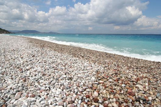 Pebble beach on the Mediterranean island of Rhodes, Greece