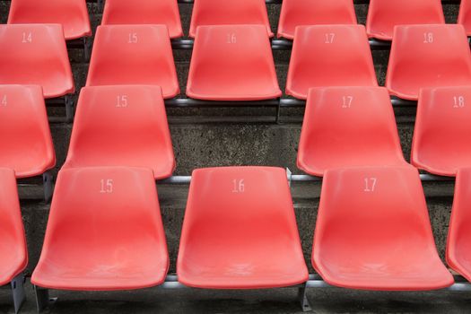 Missing Seat In Rows Of Red Seats In An Outdoor Stadium