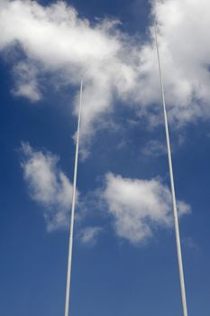 Two Poles Of A Football / Rugby Goal In Front Of A Blue Summer Sky With A White Cloud 