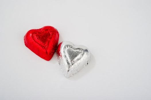 Image of two foil wrapped heart shaped candies