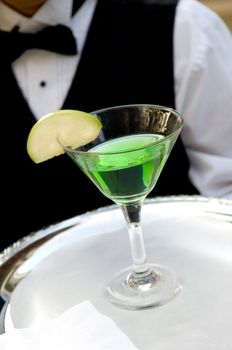 An image of a bright green apple martini