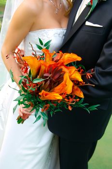 Image of a colorful bouquet being held by a bride and groom