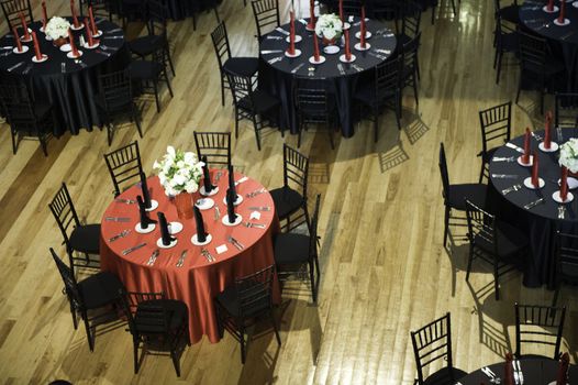 Image of several black, white, and red modern banquet tables