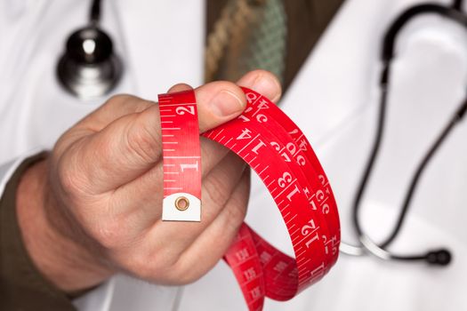 Doctor with Stethoscope Holding Red Measuring Tape.