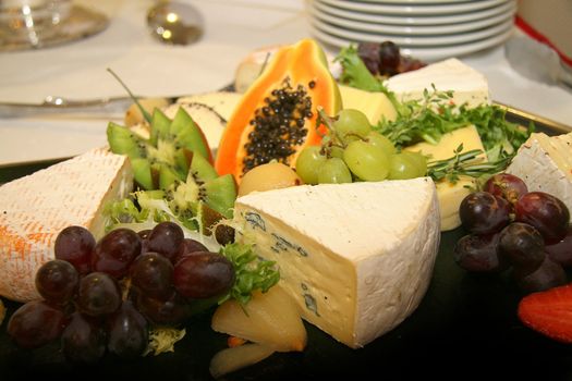 Cheese platter with different types of cheese grapes