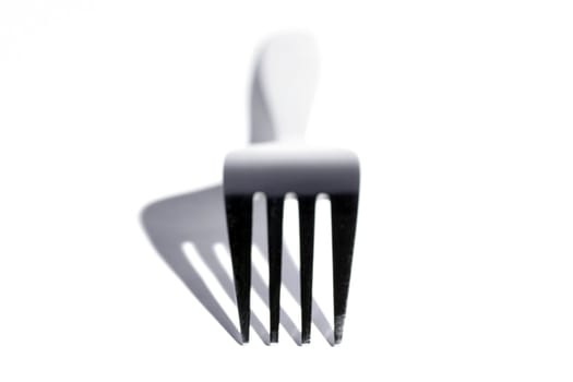 Top Os A Stainless Steel Fork With Shadow On A White Background