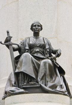 Lady Justice is not blindfolded, has dropped her scales but has her sword prominently in her right hand, as if the decision has been made, and must now be executed.