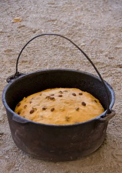 This is the result of mixing flour, sugar, yeast and raisins with some water in a pot, and heating it over a camp fire for an hour.