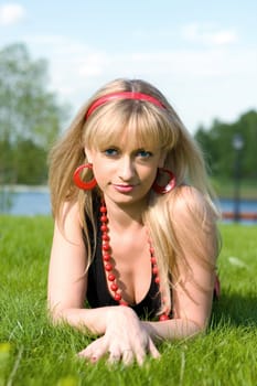 The girl lays on a grass a meadow