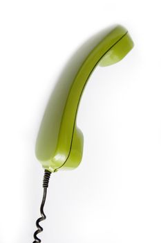 Closeup of green telephone on white