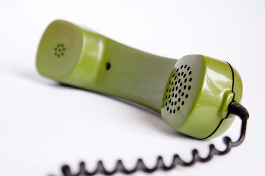 Closeup of green telephone on white