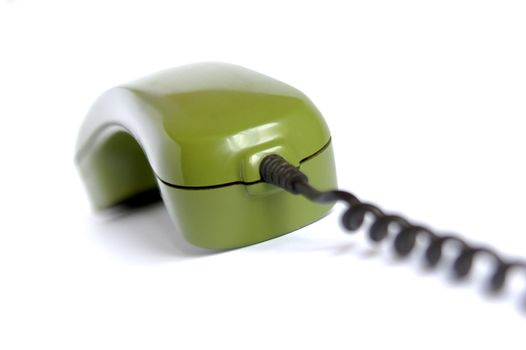 Closeup of green telephone on white