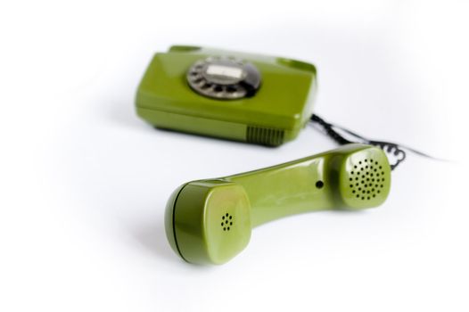 Closeup of green telephone on white