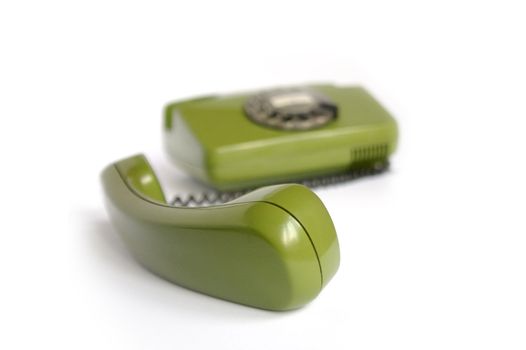 Closeup of green telephone on white