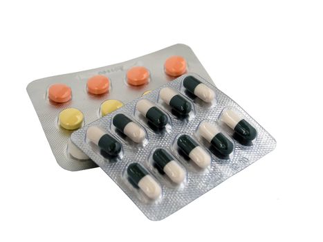 two sets of colored pills and tablets