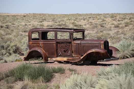 Old rusty auto abandoned in the Painted Desert of Arizona