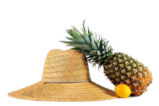 Straw hat of the farmer with pineapple and a lemon.