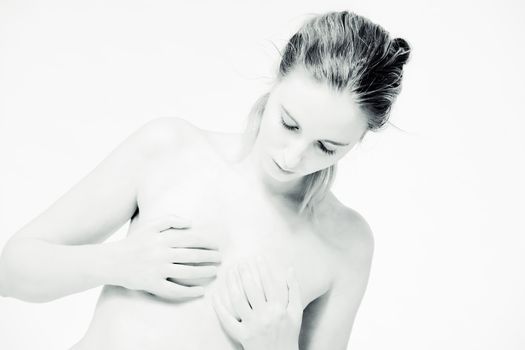 High key portrait of a model holding her boobs