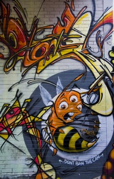 Scary graffiti bee on brick wall in urban alley in Melbourne Australia. Unblemished master piece. Includes the line: 'Dont ban the can'