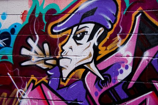 Graffiti of smoking man on brick wall in urban alley in Melbourne Australia. Unblemished cartoon. Colorful background.