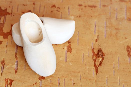 Traditional wooden holland clogs on wooden background with copy space