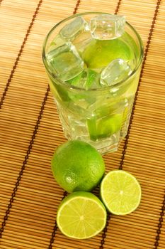 Caipirinha party cocktail with lemon and ice cubes