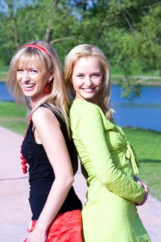 Happy young women friends have a rest in a summer garden