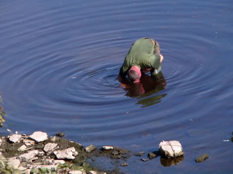 Man in the river make ripples on the water