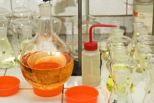 Many different flasks with liquid in chemistry lab