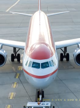 airplane preparing to flight towed a tractor to the flight bar