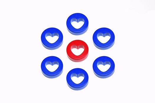 One blue heart surrounded by eight red hearts