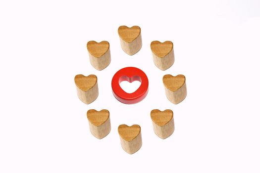 One red heart surrounded by eight wooden hearts