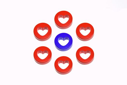 One blue heart surrounded by eight red hearts