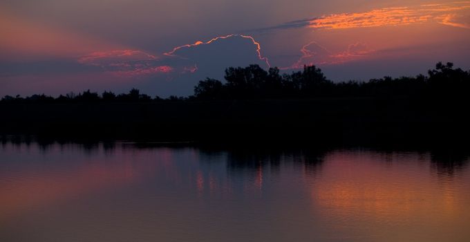 Sunrise caught behind a cloud at Lake Mitchell, South Dakota