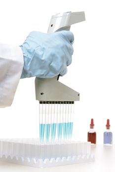 Laboratory scientist, chemist  or medical technician  using an 850� electronic pipette during research or investigation.