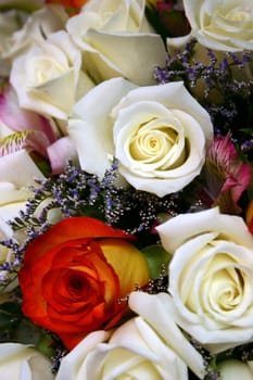 Close-up detail of a bridal bouquet, including a variety of flowers.