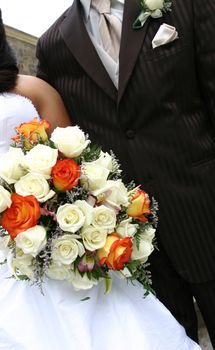 Detail shot of a bridge and grooms formalwear on their wedding day.