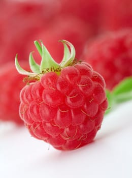 Raspberries with green leaves.This image is focused on one of them