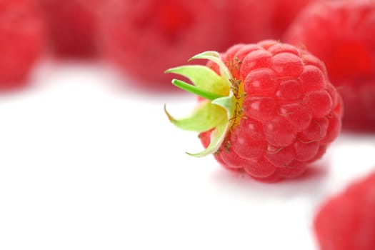 Raspberries with green leaves.This image is focused on one of them