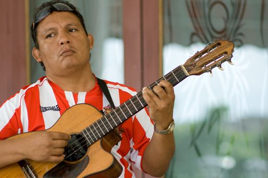 Cuban man playing guitar. January 2008, Santiago, Cuba.