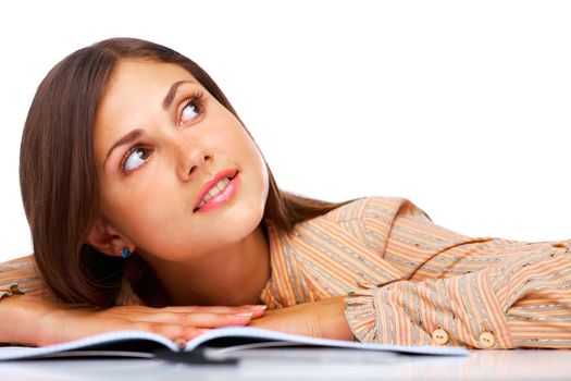 Beautiful female student smiling and looking away over white background