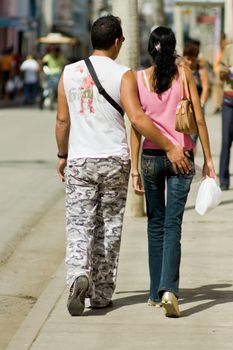 Young couple walking, view from behind. January 2008, Camaguey, Cuba.