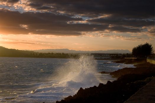 Splashes of water in the lights of dawn. Baracoa, Cuba.