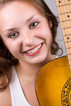 Close-up portrait of beautiful girl posing with guitar. #1
