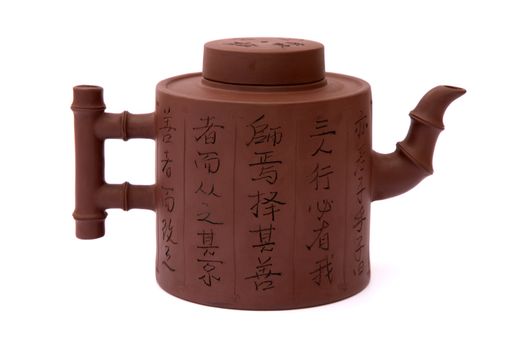 brown chinese teapot from clay with hieroglyphic on white background